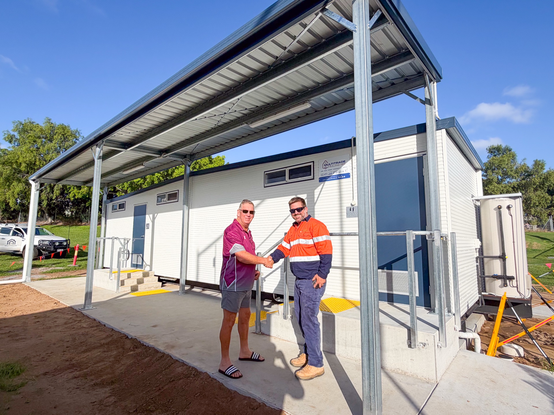 Anthony from Multitrade shaking hands with Brett Ryan at completed Gladstone Hockey amenities building
